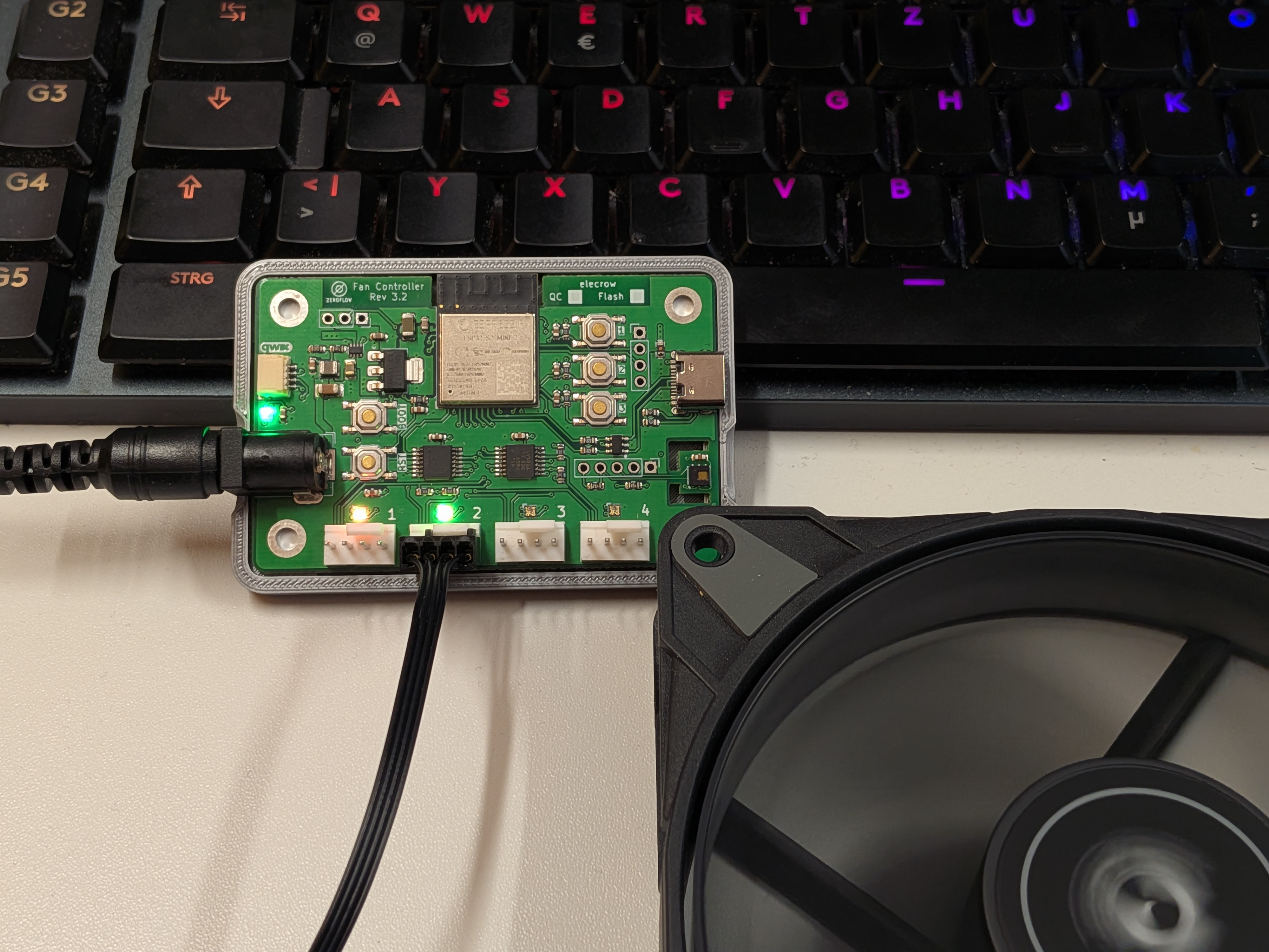 ESP32 WiFi Fan Controller Rev 3.3 PCB with Arctic P12 fan on desk during development